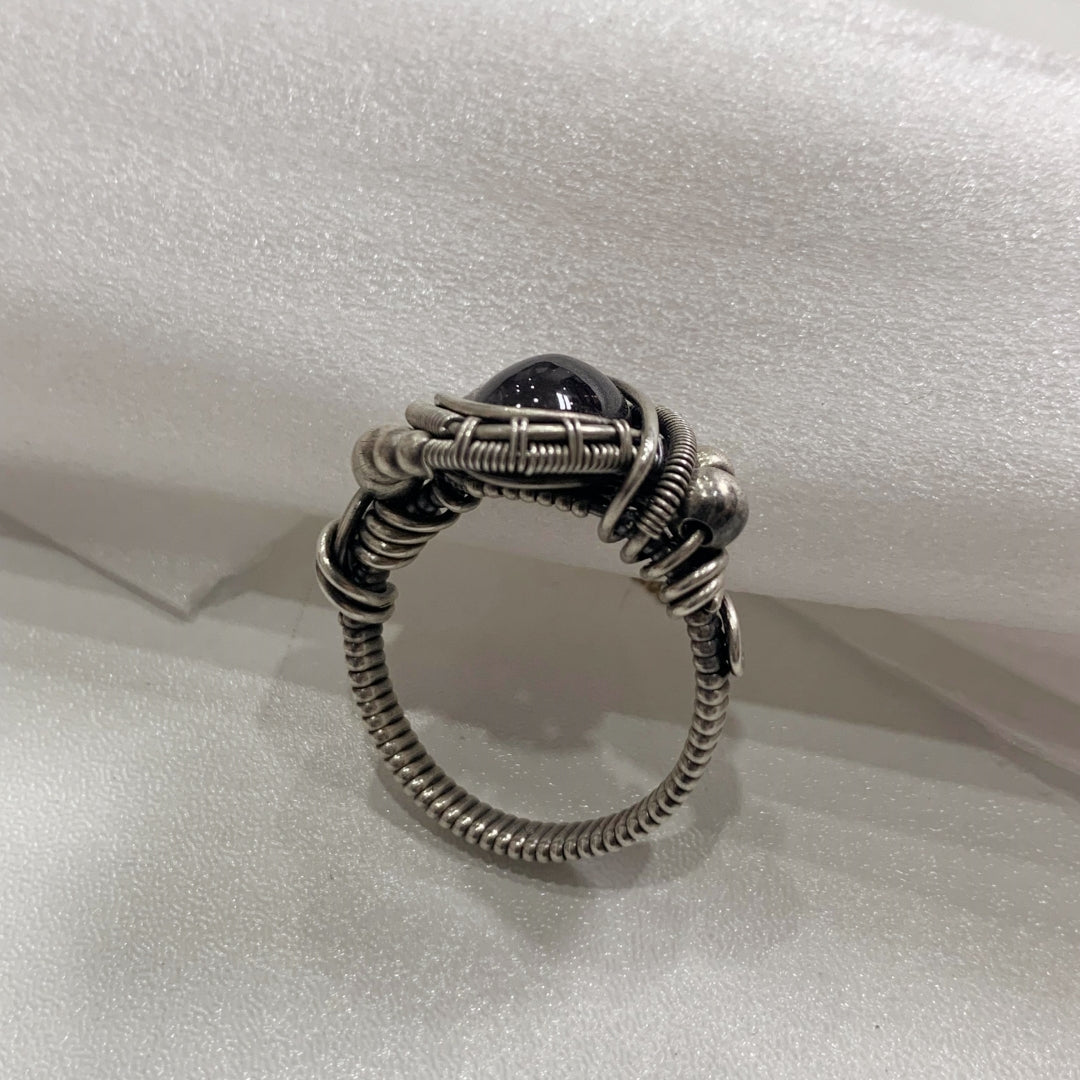 The handmade Indian Starlight Silica Wire Stone, wrapped and woven in 925 sterling silver craftsmanship.