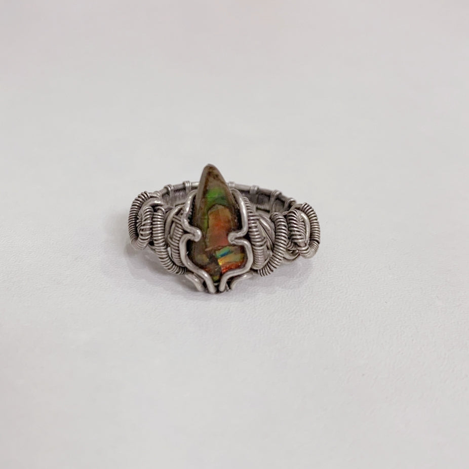 Vintage handmade silver wire braided ring with a fossil spiral design that exudes a sense of power and strength.