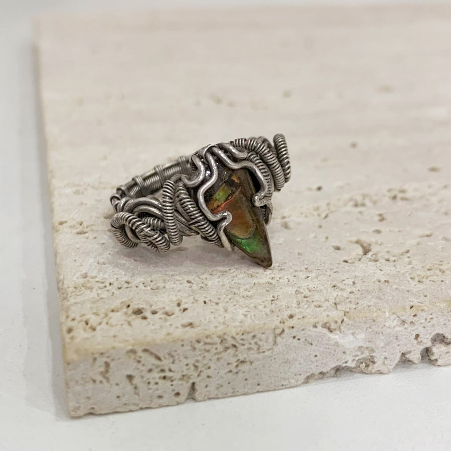 Vintage handmade silver wire braided ring with a fossil spiral design that exudes a sense of power and strength.