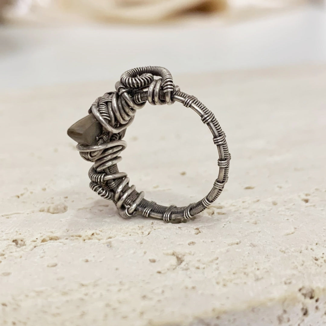 Vintage handmade silver wire braided ring with a fossil spiral design that exudes a sense of power and strength.